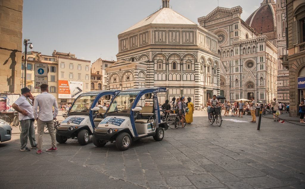 Two Golf Carts in Duomo Square, in front of the Baptistery 