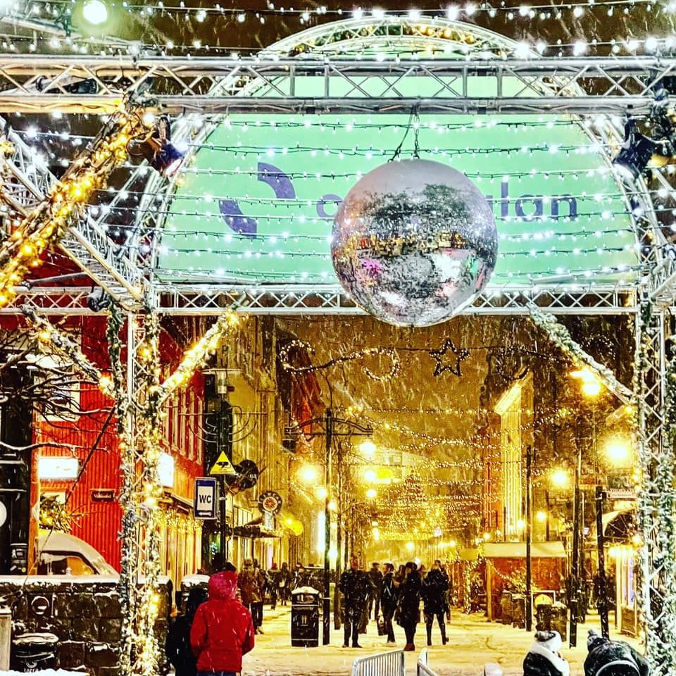 A well lit and decorated street in Reykjavik around Christmas time