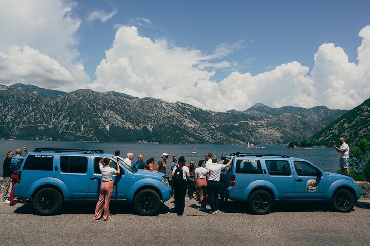 Jeep tour stop overlooking the Bay of Kotor near Perast, with views of the iconic Our Lady of the Rocks island and the surrounding mountains.