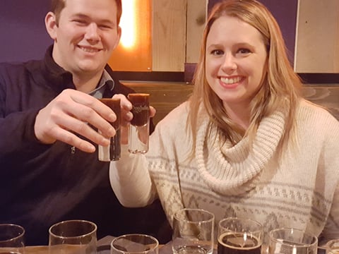 A couple enjoying a glass of snaps after sampling beers