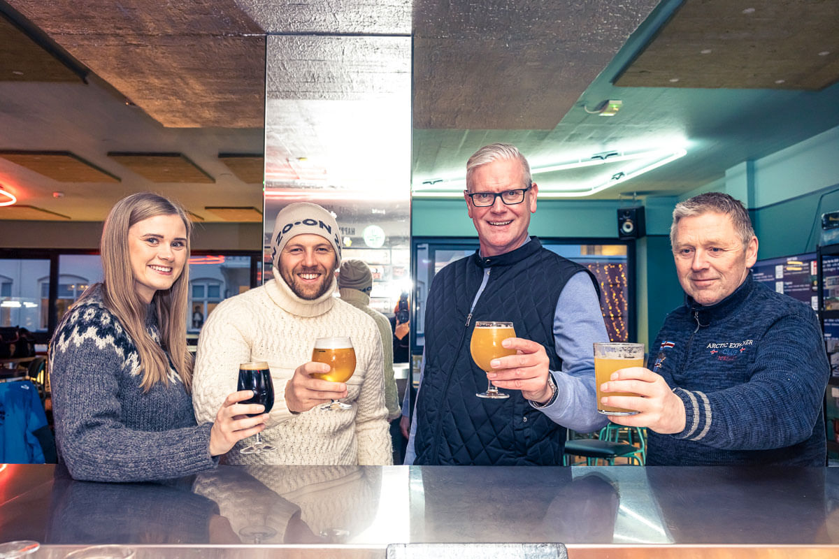 A group of travellers enjoying themselves during a beer sampling