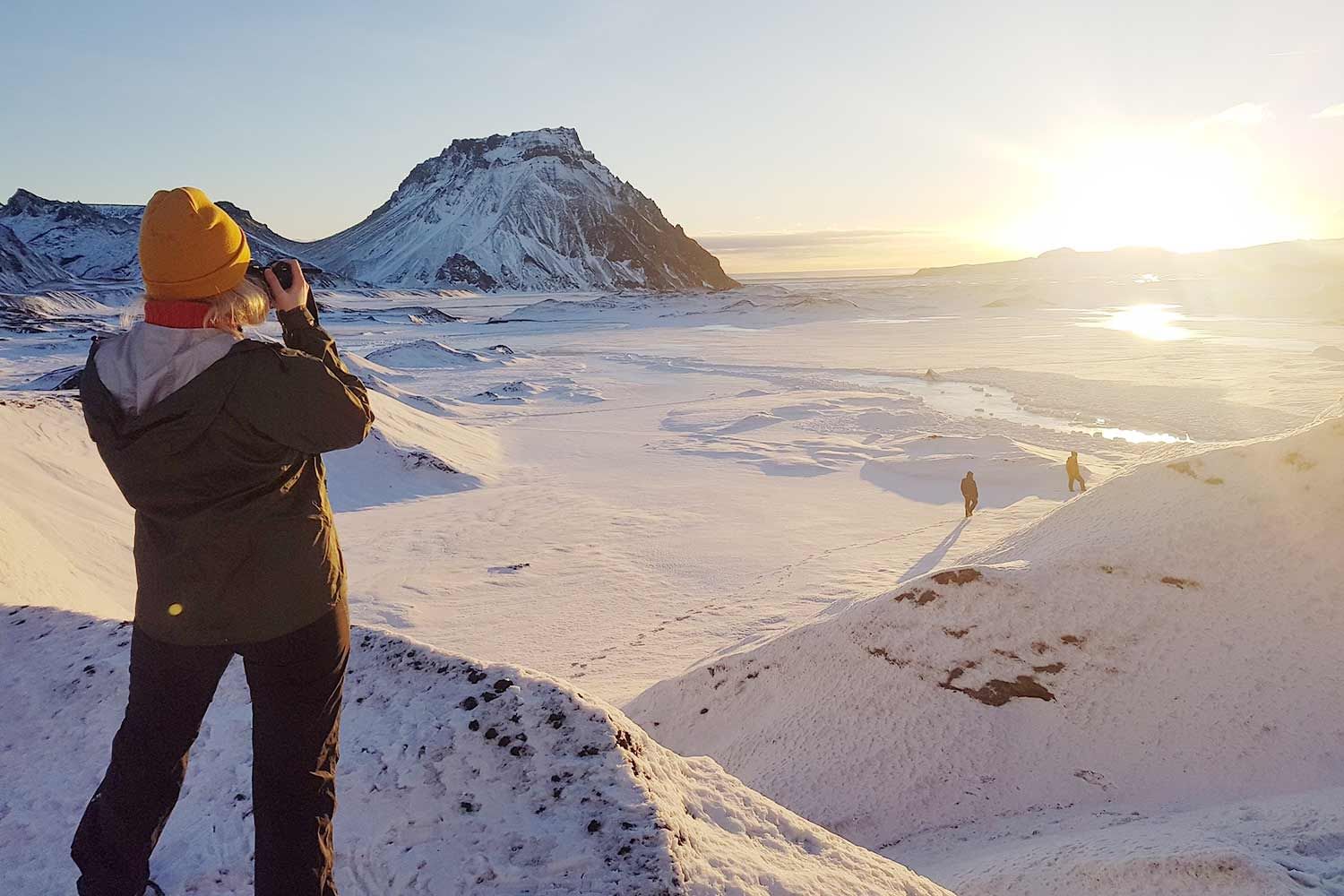 A photographer on a mountain during Katla ice cave tours Iceland