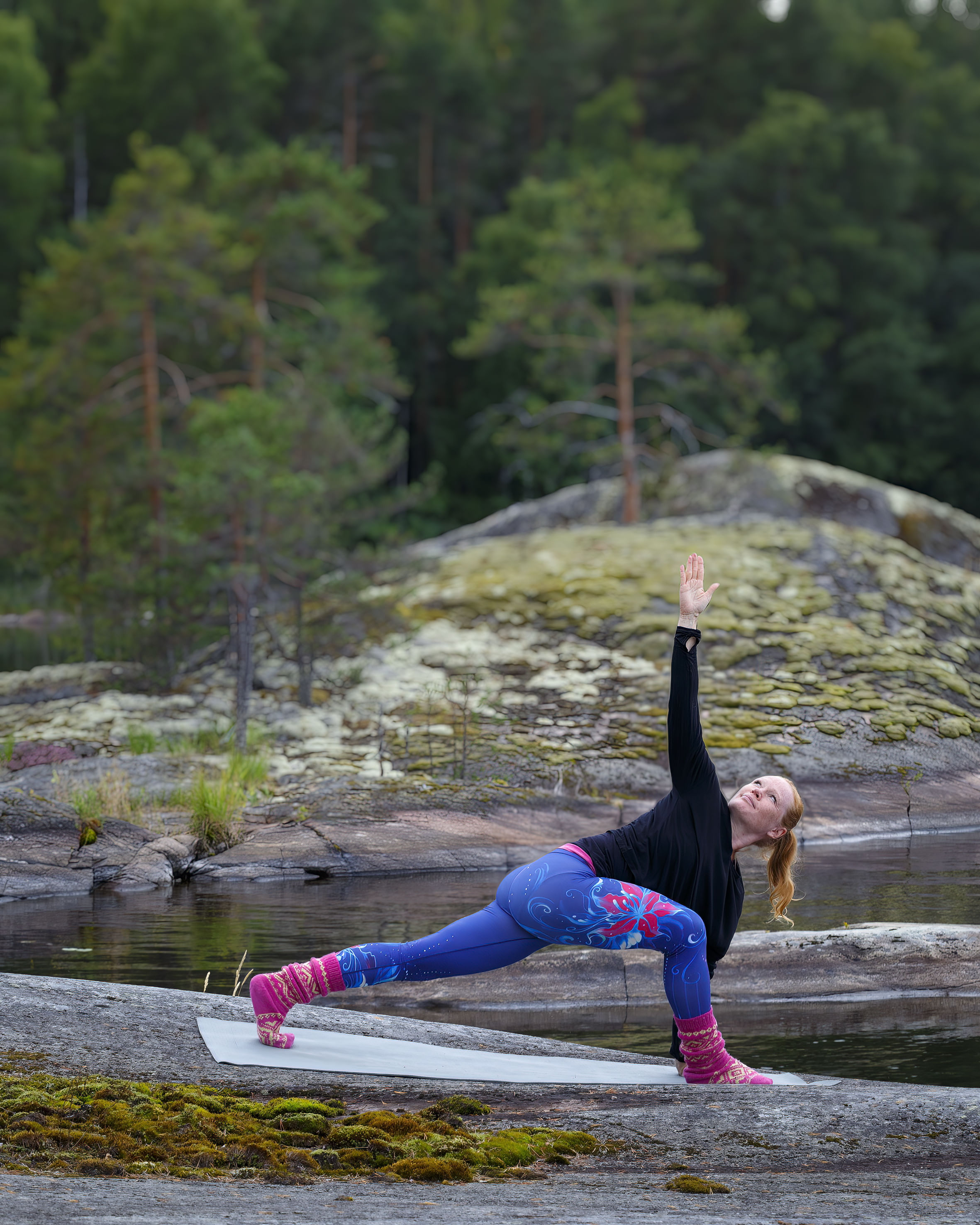 A woman exercising yoga outdoors