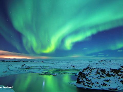 Beautiful green Northern lights over a lake in Iceland