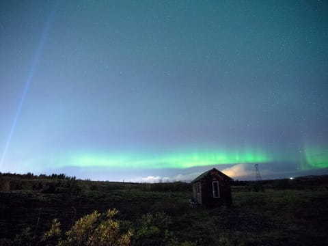 Beneath a canopy of stars, the Northern Lights weave a tapestry of cosmic splendor.