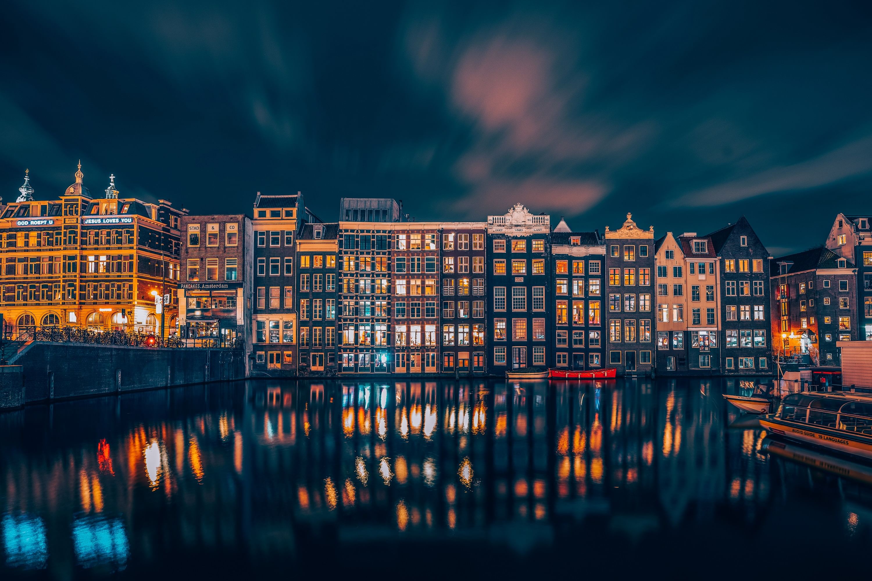 Amsterdam canal and gable houses near Central Station at nighttime