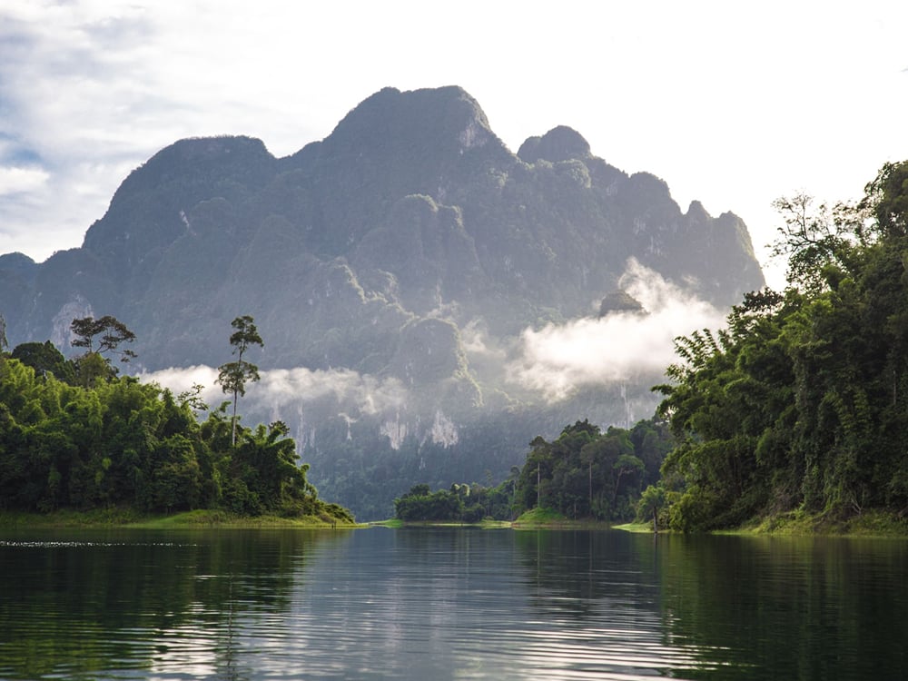Mist rising off limestone mountains over the lake