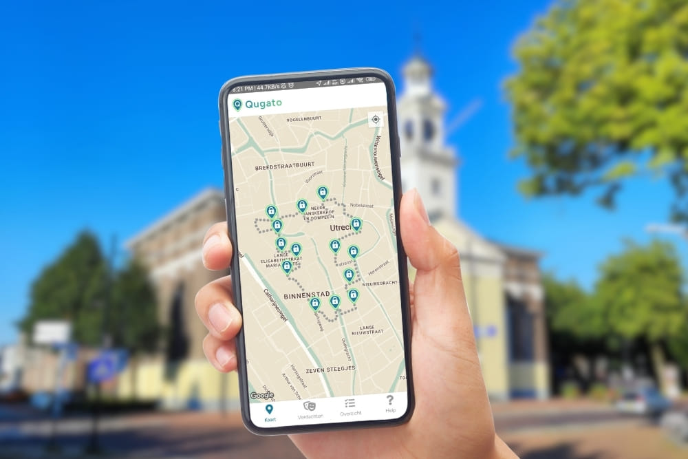 Phone showing the Qugato app interface of the Assen City Detective game at Brink.