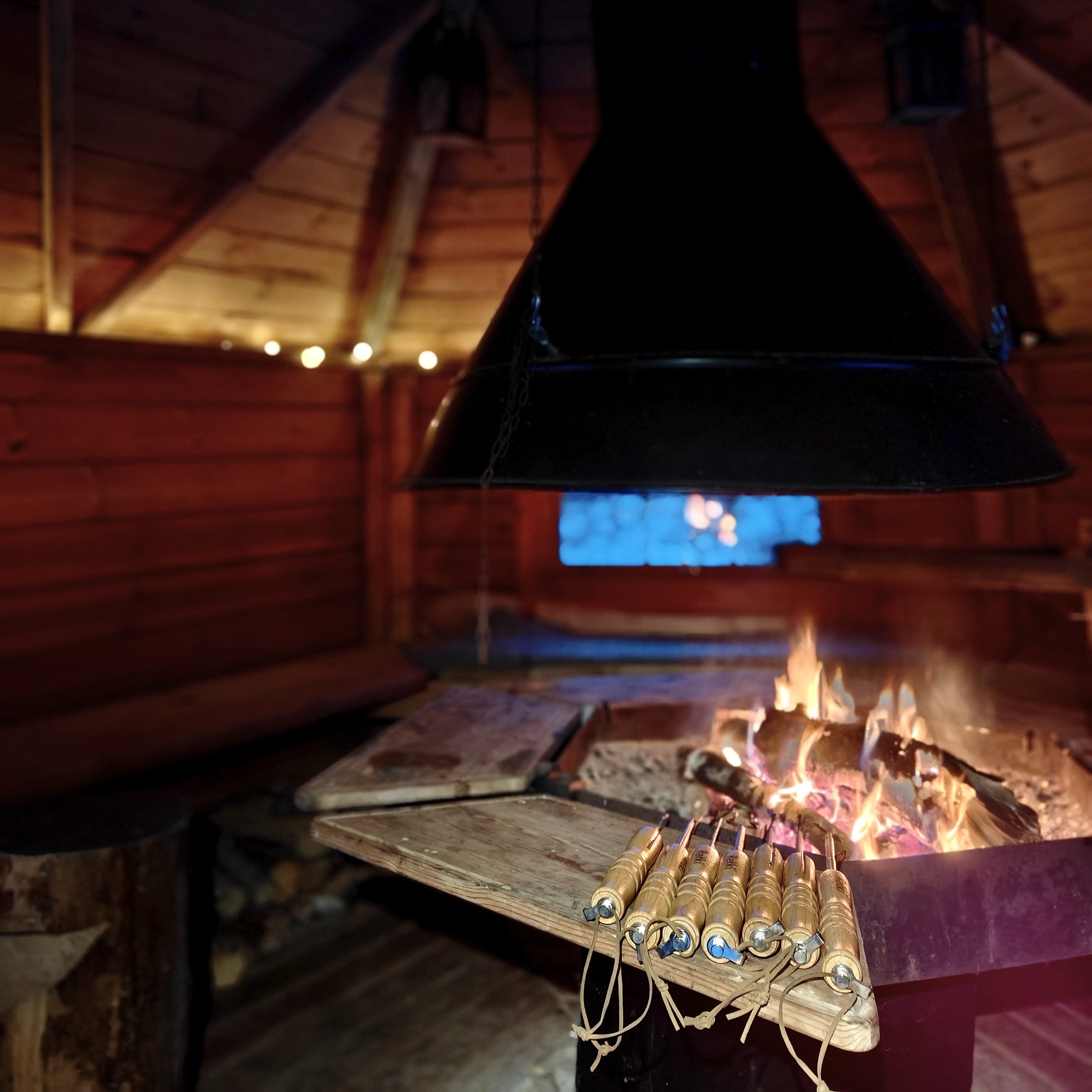 Fireplace inside a traditional kota — A glowing fire inside a wooden kota during a winter break.