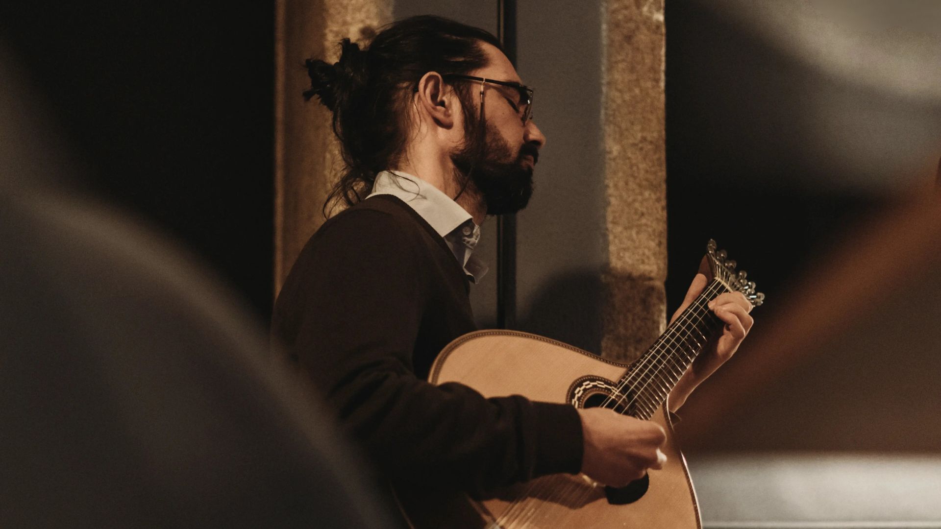 Portuguese guitar musician performing live Fado in a Porto venue