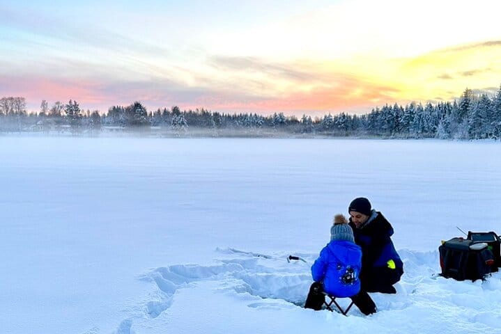 Snowmobiles parked during an Ice Fishing break in Rovaniemi with StayLapland.