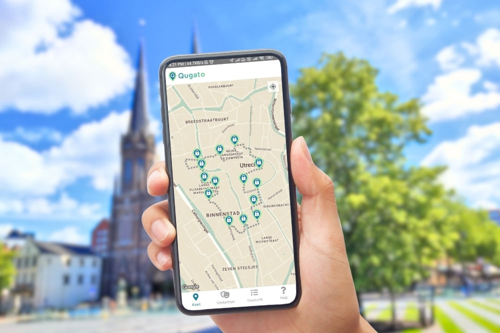 Phone showing the Qugato app interface of the Tilburg City Detective game.