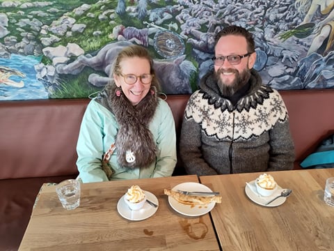 Travellers enjoying coffee and pastries in a local cafe.