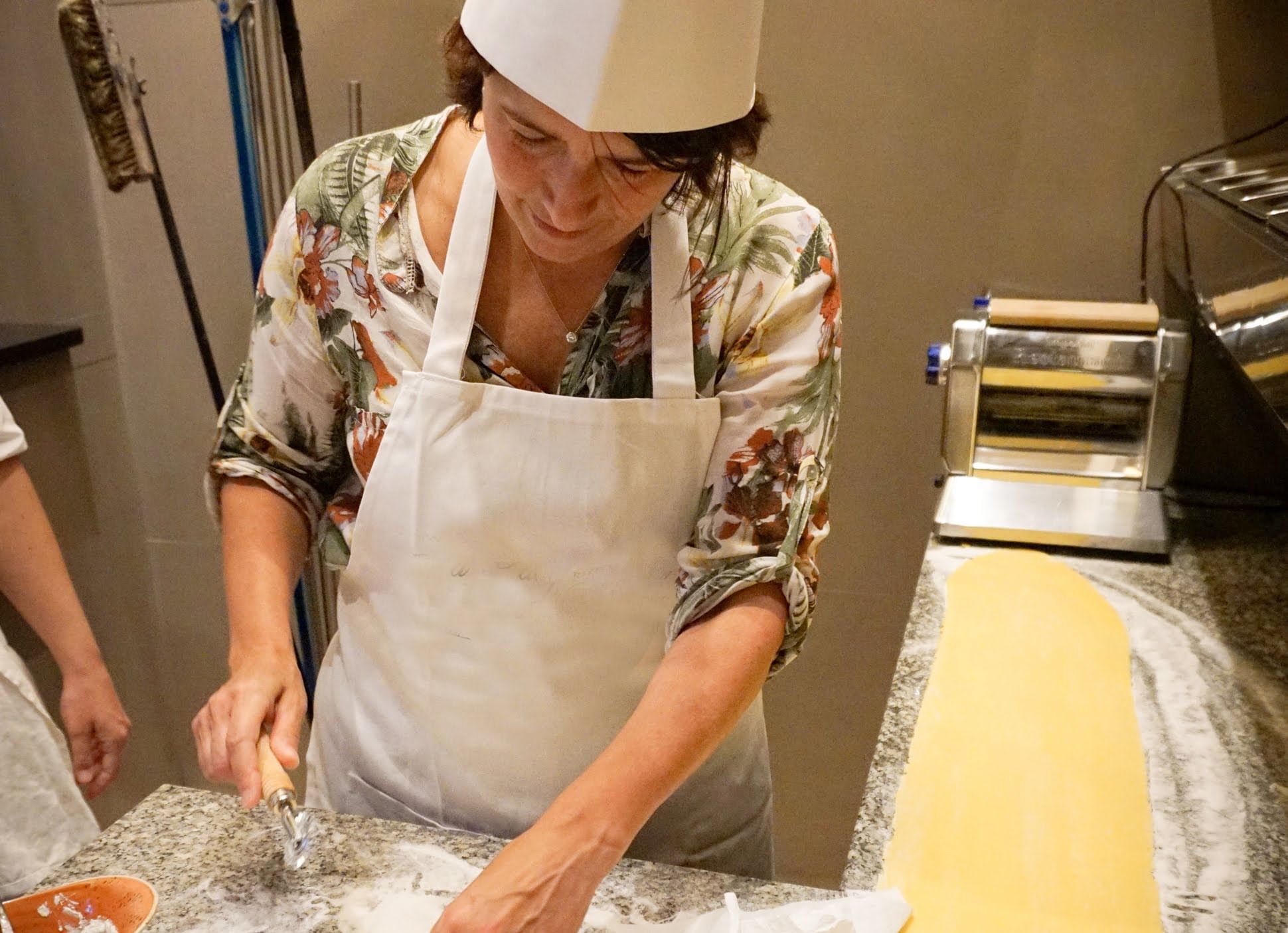 Close-up of our expert cook cutting fresh-made pasta
