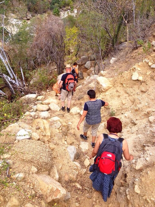  Group hiking santiago canyon desert trail adventure cabo hiking tour rocky path nature experience mexico.