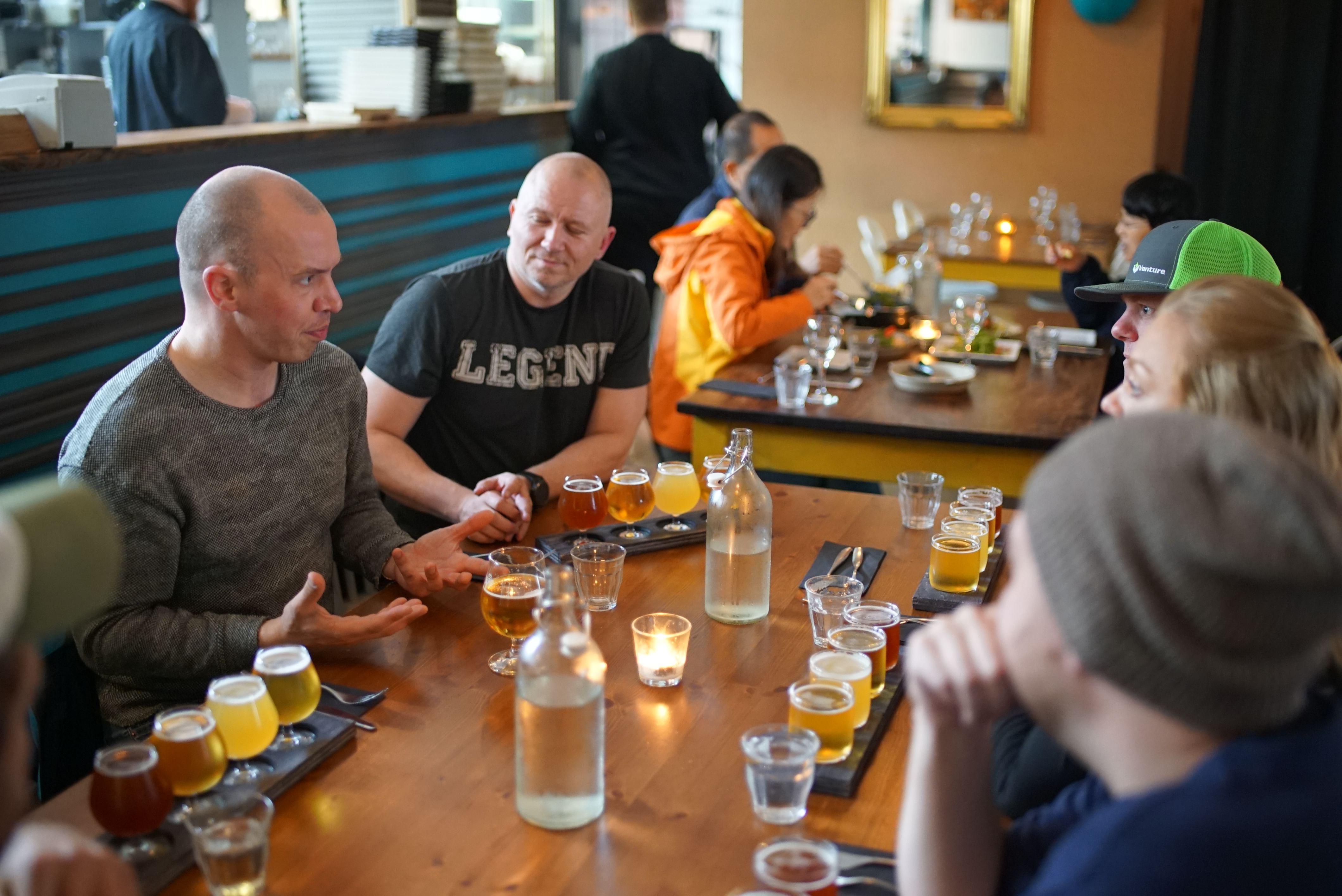 A group of guests sampling different beers while chatting