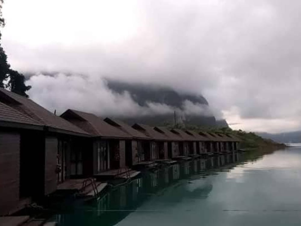 Floating bungalows under low mist