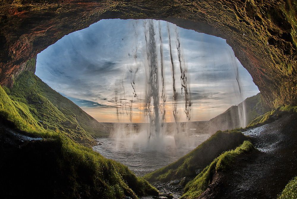 Walk behind Seljalandsfoss waterfall and feel the power of the elements