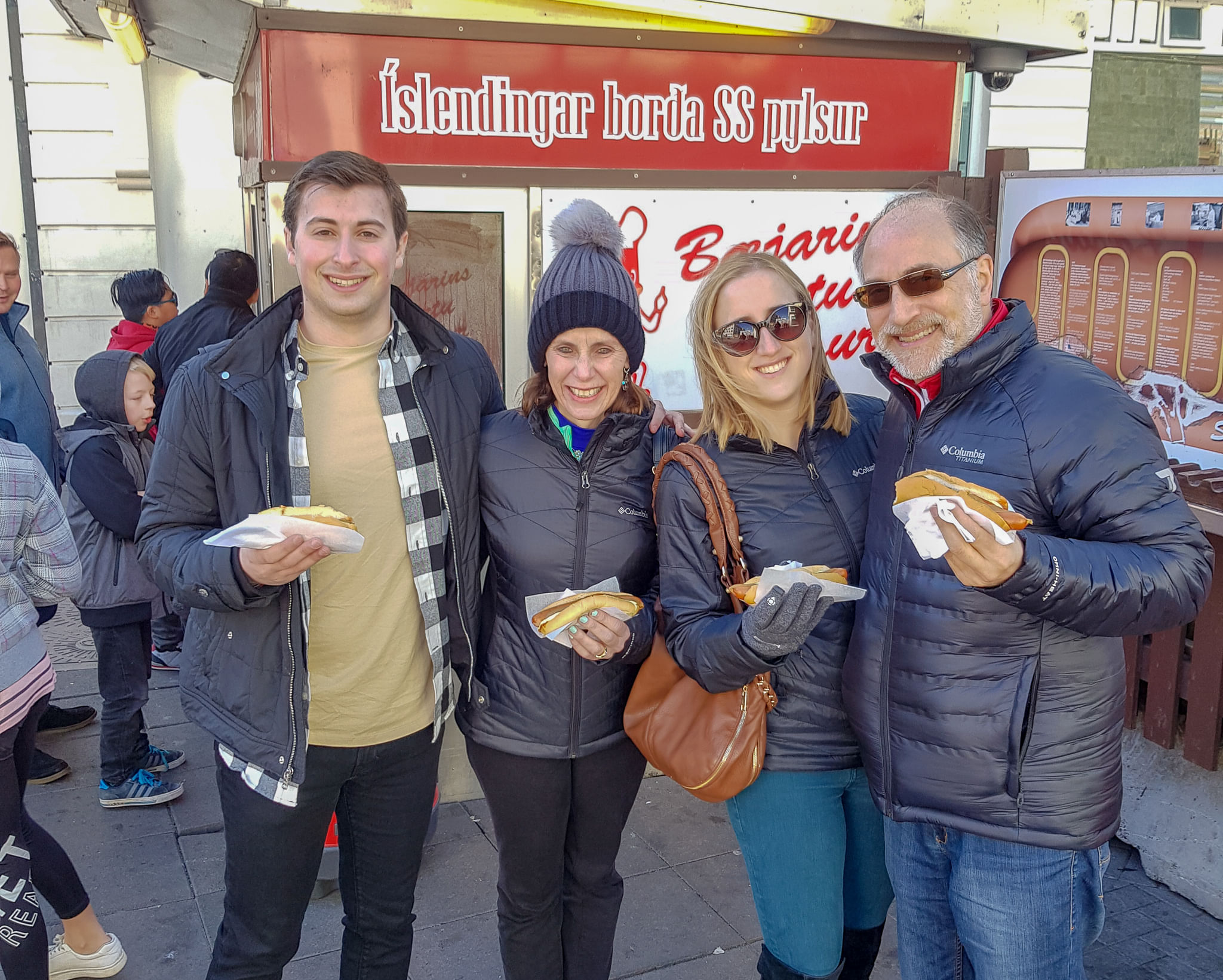 A family enjoying the Icelandic hot dog at the original food stall which dates from 1937