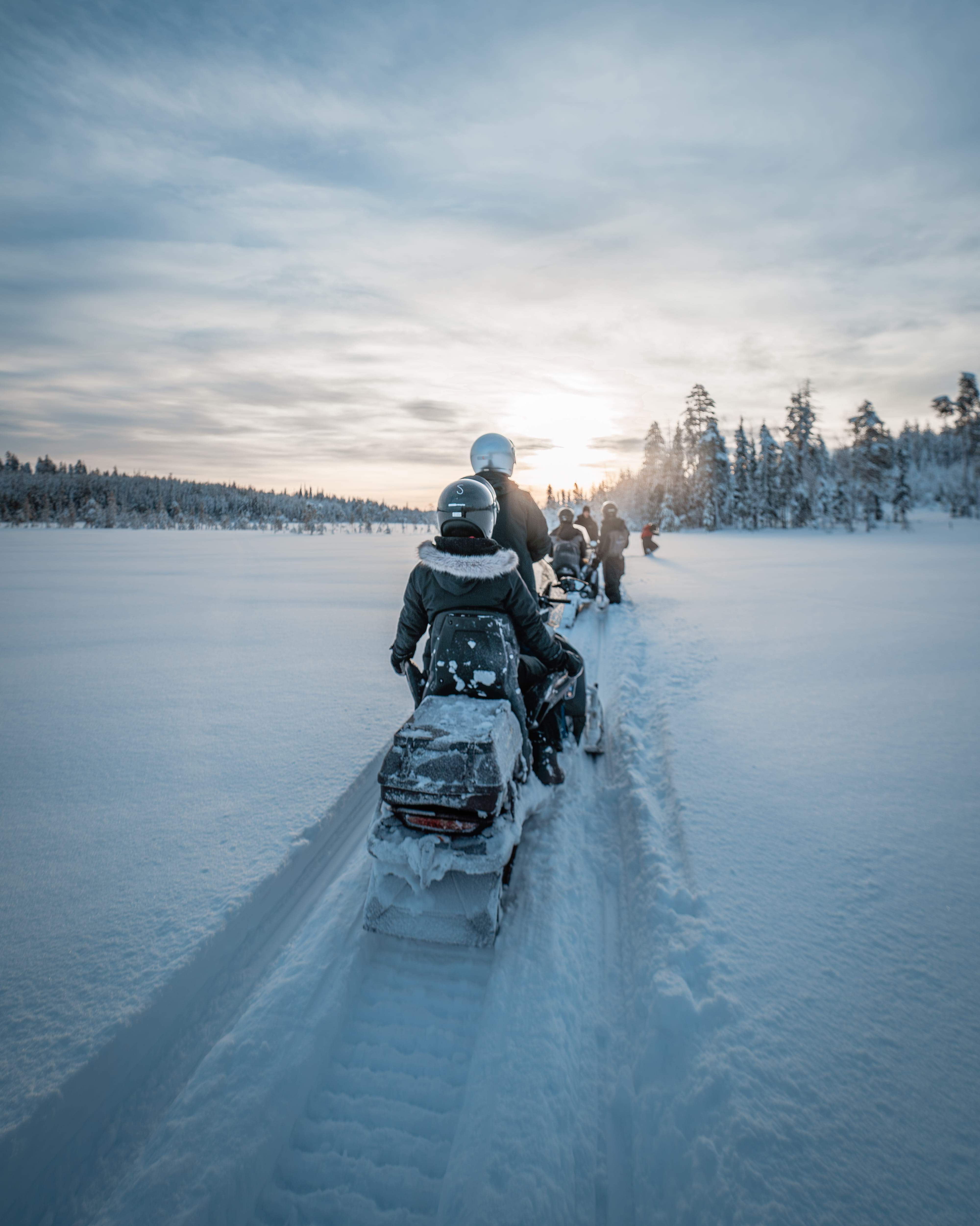 A snowmobile driving through the snowy wilderness as part of StayLapland’s Kuoksa Husky & Snowmobile Adventure in Rovaniemi.