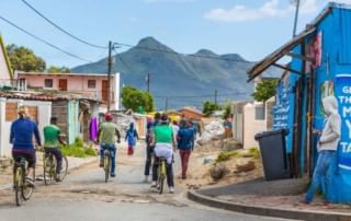 Breathtaking mountain views serve as a backdrop while cycling through the colourful township streets.