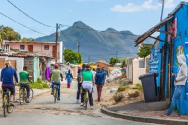 Breathtaking mountain views serve as a backdrop while cycling through the colourful township streets.