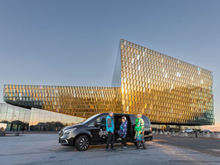 Group of travellers meeting the Guide from Your Friend in Reykjavik in front of the Harpa Concert Hall