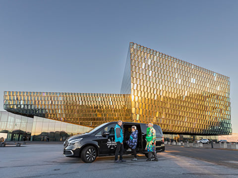 Group of travellers meeting the Guide from Your Friend in Reykjavik in front of the Harpa Concert Hall