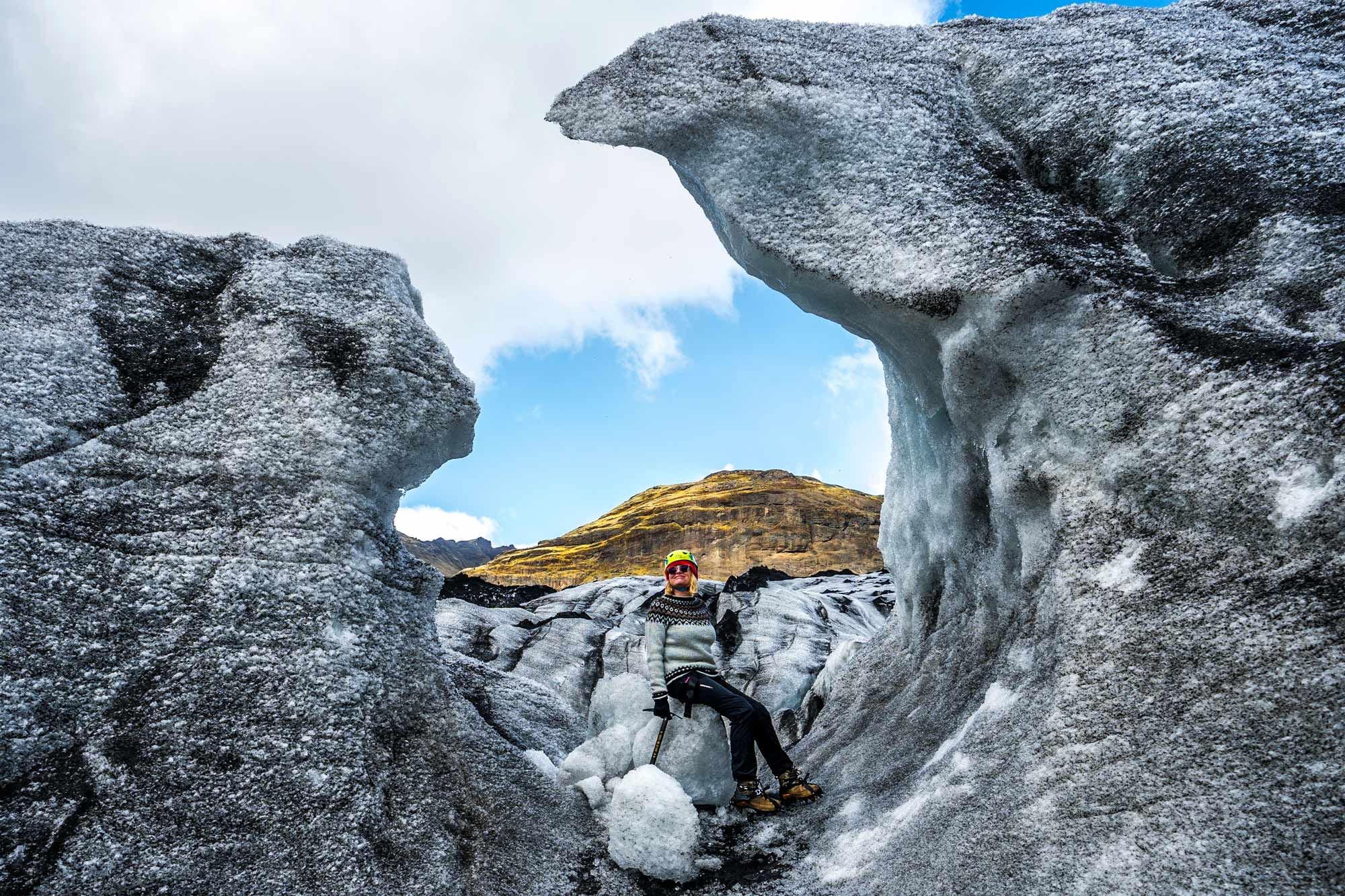 Woman sitting around icicle skulptures.