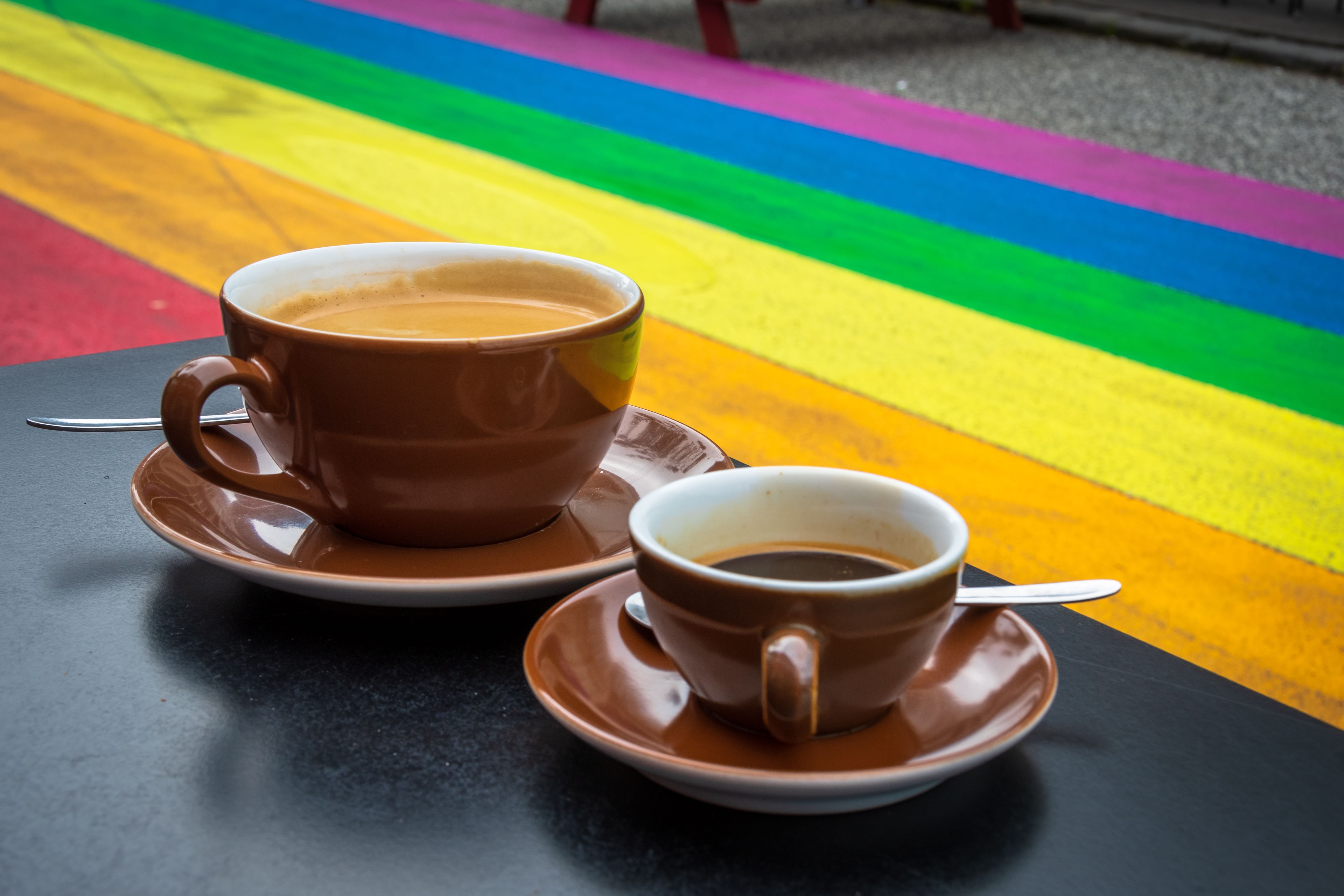 Two cups of coffee on a table next to the Rainbow Street