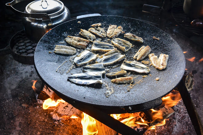 Baltic herring fried on open barbecue fire. Just on of many dishes served on the island.
