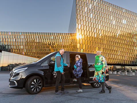 Travellers entering a tour vehicle from Your Friend in Reykjavik