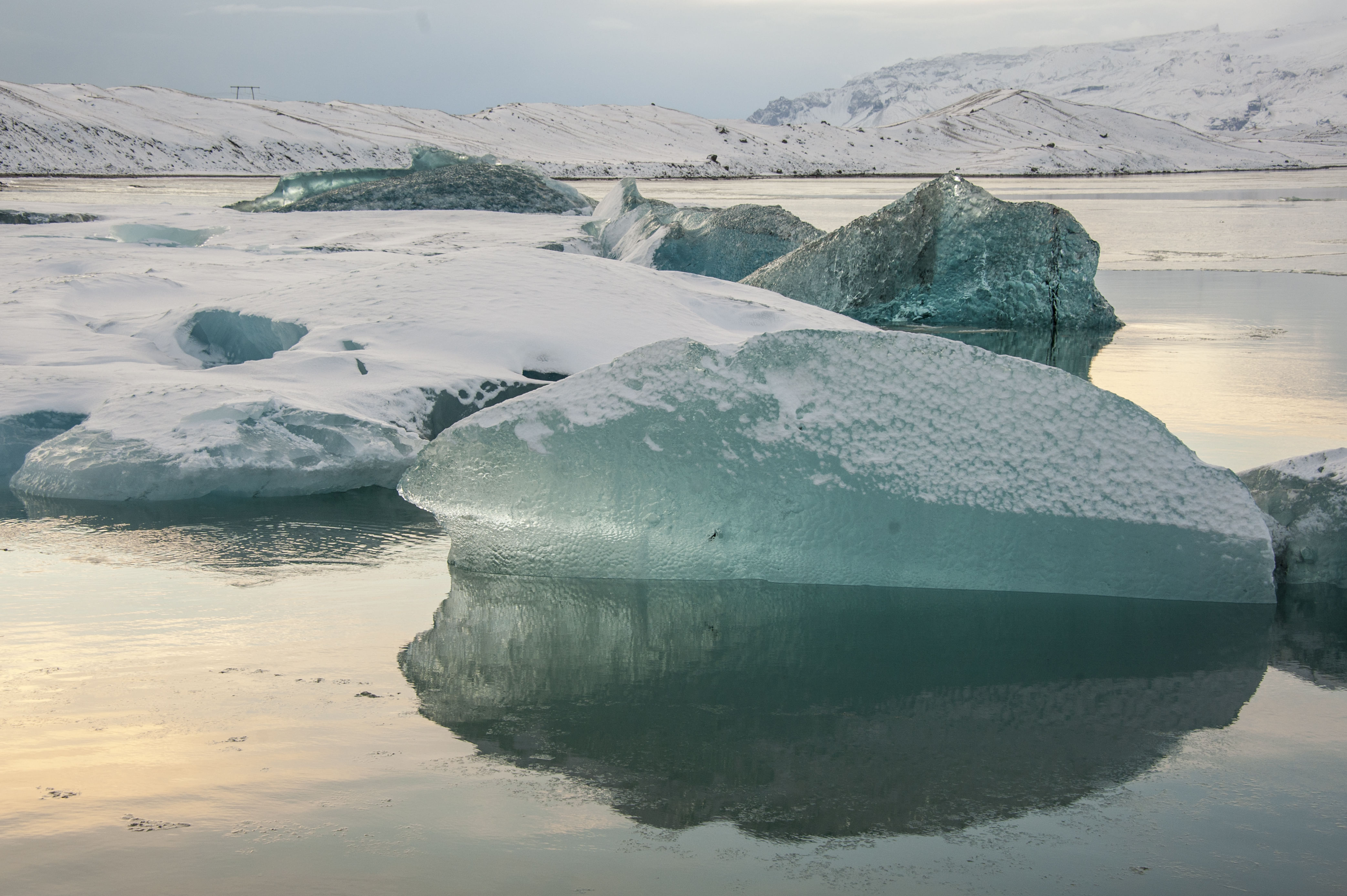 Marine green icebergs covered with fresh snow