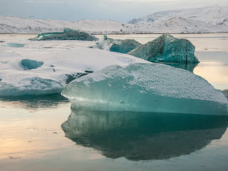 Marine green icebergs covered with fresh snow
