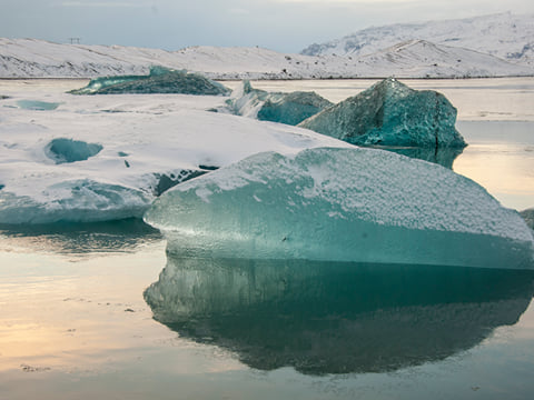 Marine green icebergs covered with fresh snow