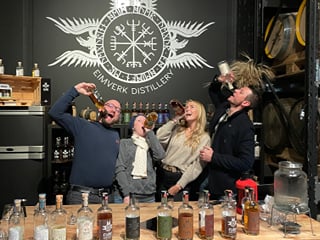 A tour group posing for a picture at Eimverk Distillery