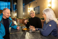 A group of guests enjoying various food items in a restaurant. 