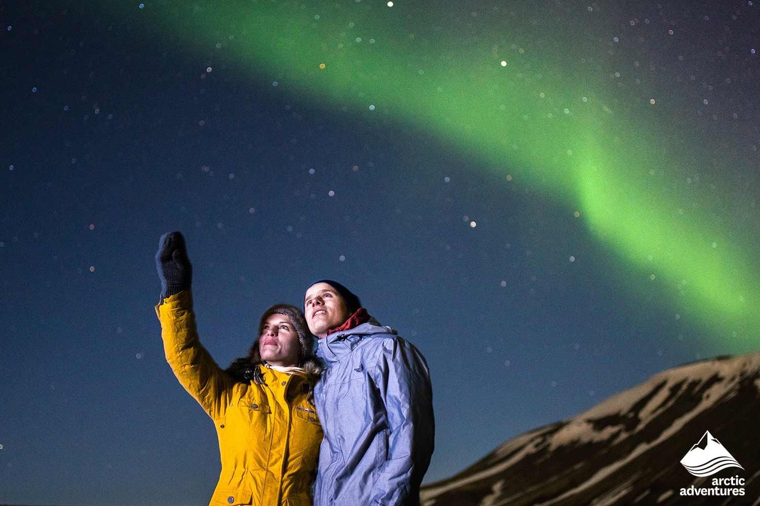 People enjoying Northern lights during 4 day tour Iceland