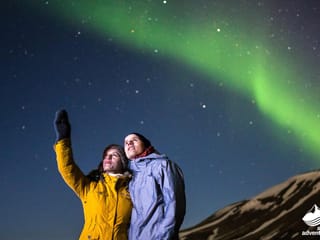 People enjoying Northern lights during 4 day tour Iceland