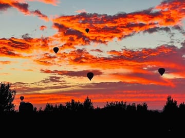 Licensed pilot preparing hot air balloon flight over Marrakech with safety briefing before sunrise