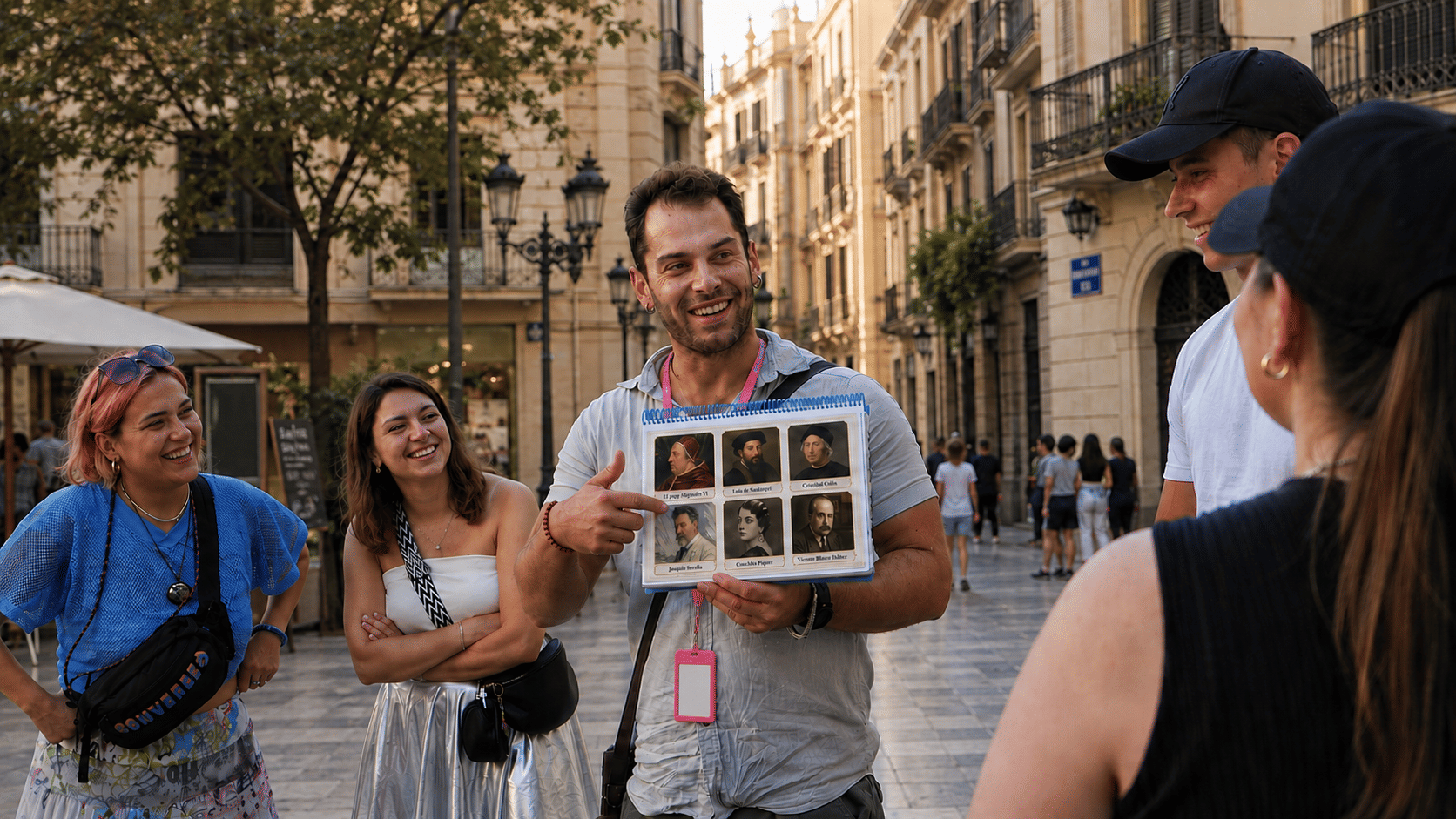 Guide showing historical figures and explaining hidden stories to a small group during a walking tour in Valencia