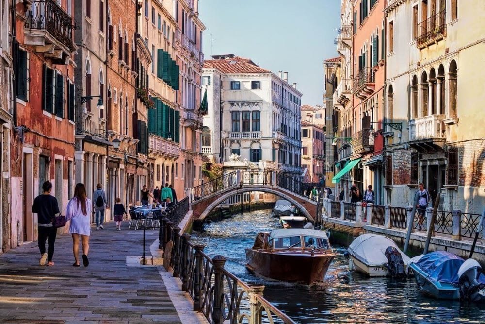 Charming canal and stone bridge in Murano, Venice Italy