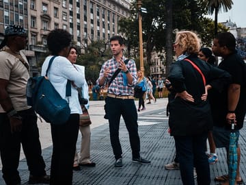 Guide greets a small-group of travelers in Plaza de Mayo, Beunos Aires, for a sightseeing city tour.