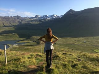 Woman gazing at the landscape from mount Kirkjufell