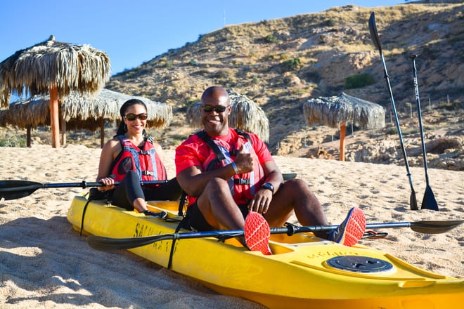 kayak Los Cabos beach break couple relaxing after ocean adventure Baja
