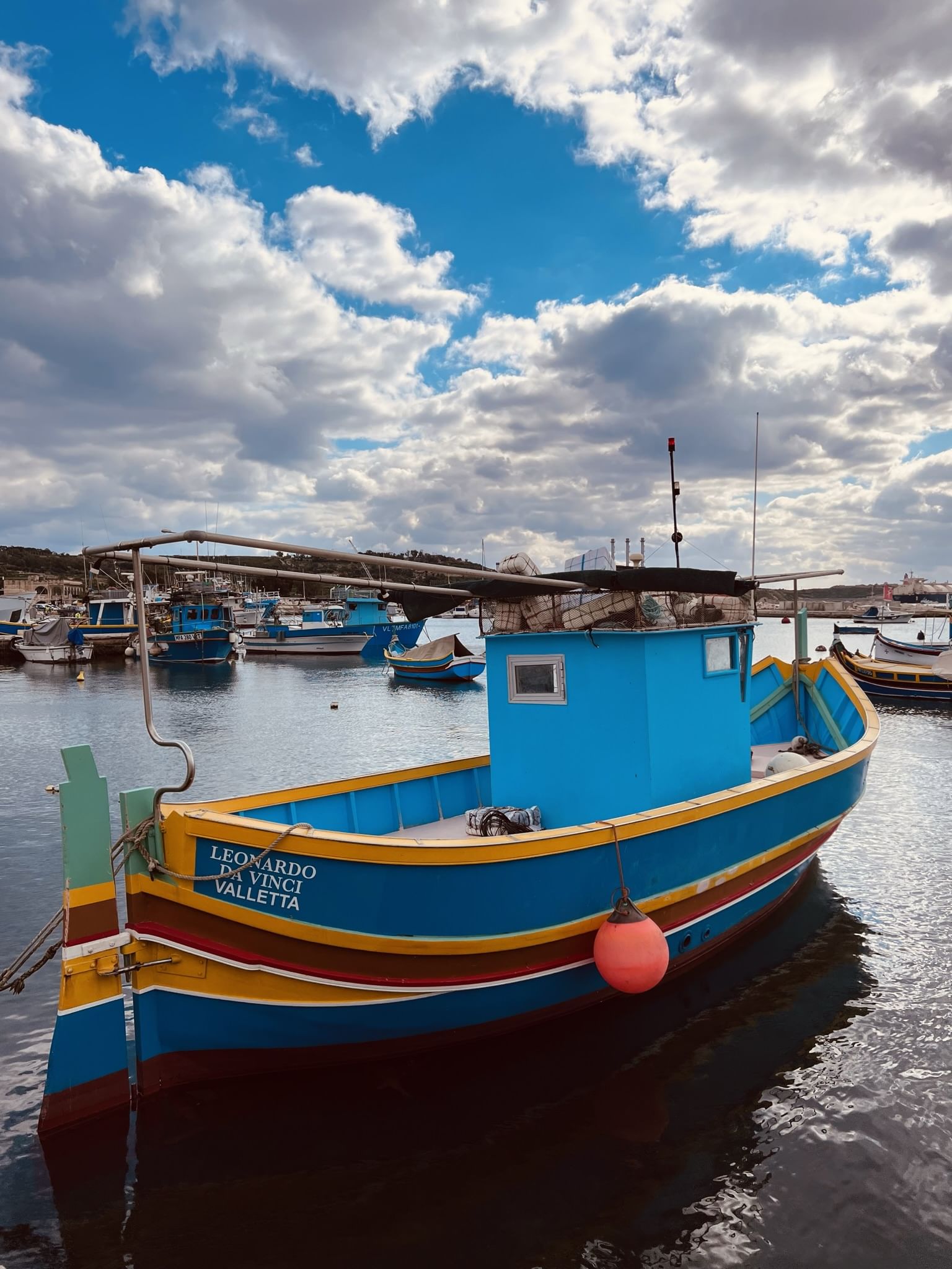 Traditional colourful boat in Marsaxlokk bay