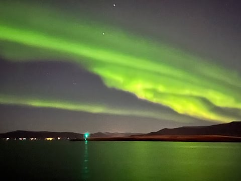 Northern Lights in the night's sky above the ocean