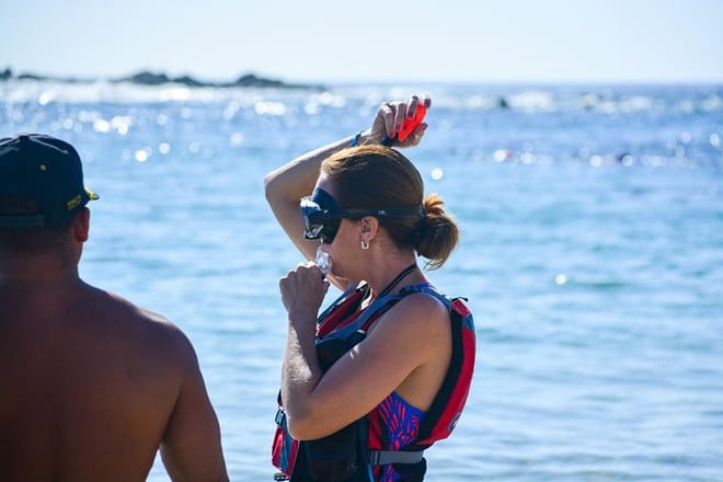 Woman receiving snorkeling safety instructions from guide Los Cabos ocean tour