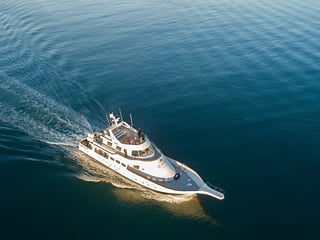 An aerial shot of a yacht at sea