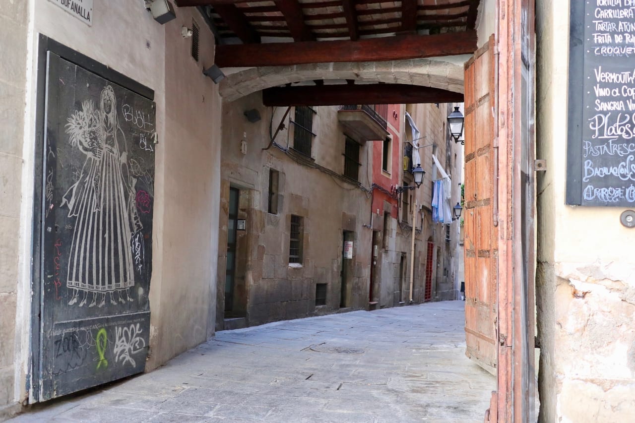 An empty narrow back alley in the historic center of Barcelona - off-the-beaten-track